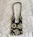 Black and white knit shoulder bag with peach pattern and chic checkered handle design. - Shoulder Strap Model / Black