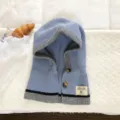 Detailed view of the blue knitted hooded scarf with buttons and contrast trim, cozy winter wear. - Integrated Hooded Scarf / Sky Blue
