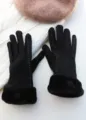 Close-up of black winter women gloves with warm fur cuffs and elegant white stitching details. - Black