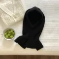 Close-up of black knitted balaclava hooded scarf, soft warm wool knit texture detail shot. - Black