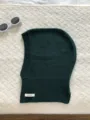 Dark green 100% wool knitted balaclava hood detail showcasing soft texture and warm winter wear. - Dark Green