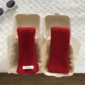 Red knitted wool arm sleeves detail view in eco-friendly gift box packaging style - Red