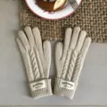Detailed close-up of beige cable knit winter gloves, warm wool texture for cold days. - 29x10cm / Ivory