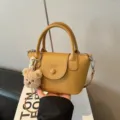 Small yellow PU leather handbag with cute bear pendant, top handle crossbody bag for women. - Khaki