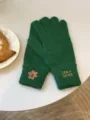 Detailed close-up shot of green knit gloves featuring cute embroidered bear and text design. - 30x12cm / Green