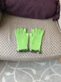 Green knitted touch screen gloves for women with cute ruffles and finger embroidery. - Verdant