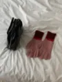 Close-up of cute colorblock knit gloves in pink and red, warm winter five-finger design. - Pink