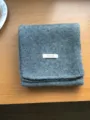 Detailed shot of grey knit wool scarf, showing soft texture and fine fabric craftsmanship. - Dark Gray