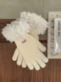 Detail shot of cozy knit touchscreen gloves with fluffy fleece cuffs on wooden surface. - 25x10cm / Ivory