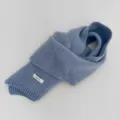 Detailed view of the fog blue knitted wool scarf close up showing soft fabric texture and label. - Fog Blue
