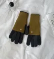 Detail view of colorblock knit gloves on white fabric with minimalist props for winter warmth. - 24x12cm-W205P / Dark Gray