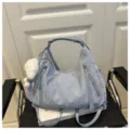 Light blue casual hobo shoulder bag with front dual zippers and cute plush pendant charm detail. - Blue