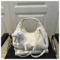 Detail view of the stylish white hobo shoulder bag with cute cloud pendant and zipper pockets. - Without Pendant / White