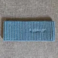 Nahaufnahme Detail des blauen Rippstrick-Stinrands mit gestickten Buchstaben Textur. - Blau