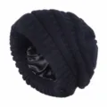 Detail view of a black satin-lined knit beanie, warm windproof slouchy winter hat. - Black