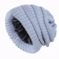 Detail close-up of the grey knitted beanie showcasing the smooth black satin inner lining. - Light Gray