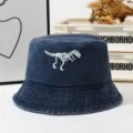 Vintage washed denim bucket hat featuring a cool white dinosaur skeleton embroidery design. - One Size / Navy Blue