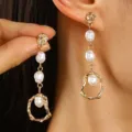 Elegant gold-tone irregular metal drop earrings with white baroque pearl detail on model - Irregular Artificial Pearl (2489) / Gold