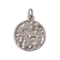 Close-up of the embossed Aries ram zodiac symbol on a textured metal round pendant charm. - Capricorn