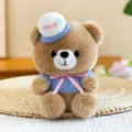 Simpatico orsetto di peluche marrone con cappello da marinaio blu e nastro rosa, morbido. - Orso bruno / 13cm