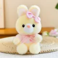 Cute yellow plush animal doll with pink bow and dress, soft stuffed toy for desktop decoration. - Rabbit