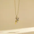 Detail shot of a minimalist two-tone hugging figures pendant necklace with delicate beaded chain. - Style 7