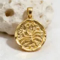 Gold zodiac coin pendant detail view, showing intricate relief pattern and polished metallic surface. - Scorpio