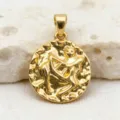 Close-up shot of vintage gold coin pendant featuring detailed zodiac relief design. - Sagittarius