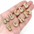 Close-up detail shot of sparkling cubic zirconia gold-plated balloon letter charms for DIY jewelry. - Pendant A / L / Gold