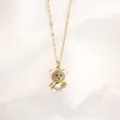Gold teddy bear necklace detail featuring sparkling crystal pendant and delicate link chain. - Pendant And Necklace Set / White