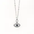 Evil eye pendant necklace detail view, exquisite pavé crystal silver tone chain aesthetic design. - Pendant Necklace Set / Silver