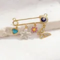Close-up details of gold evil eye safety pin brooch with multi charms sweet style. - Style 1 (Pendant)