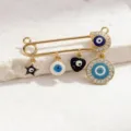 Close-up detail view of trendy gold evil eye safety pin brooch with sparkling charms. - Style 4 (Pendant)