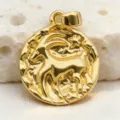 Close-up detail of vintage gold zodiac coin pendant with textured relief design and glossy finish. - Capricorn