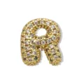 Detaillierte Nahaufnahme eines vergoldeten und mit Strass besetzten Buchstaben R. - Gold Buchstabe R