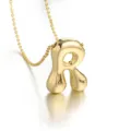 Close-up detail shot of a 3D gold bubble letter R pendant necklace, polished finish. - Letter R