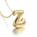 Gold plated balloon letter Z pendant necklace, stylish minimalist design closeup jewelry detail. - Letter Z