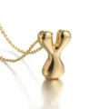 Detail shot of an 18k gold plated puff letter Y pendant necklace with a fine chain shine. - Letter Y