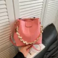 Pink woven bucket bag for women, retro style shoulder bag with chain and scarf for daily commute. - Pink