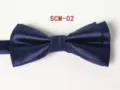 Detail shot of a dark blue double layered bow tie with elegant textured fabric finish. - Dark Blue