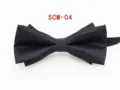 Detailed close-up of a classic black textured men's formal bow tie, showing fabric. - Black Twill