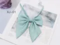 Detailed view of a mint green shiny JK bow tie, perfect for school uniform and daily wear. - Mint Green