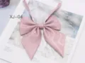 Detailed close-up of the sparkling pink JK uniform bow tie, cute college style collar accessory. - Cherry Pink