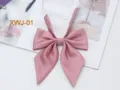 Detail shot of a pink ribbed pointed bow tie, showing fine fabric texture and neat stitching. - Pink