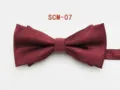 Close-up view of wine red men's formal bowtie showing smooth fabric texture and details. - Burgundy Twill