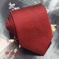Detail view of a burgundy red jacquard woven polyester tie with fine striped texture for formal wear. - Dark Red Twill (HCD-07)