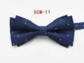 Detailed view of a dark blue double-layer men's bow tie with delicate white dot patterns. - Navy Blue Floral