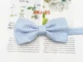 Detail view of a stylish blue polka dot men's bow tie, perfect for formal suits and grooms. - SNJ-05