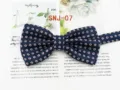 Detail shot of classic men's navy blue bow tie with red white geometric floral pattern. - SNJ-07