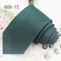 Detailed view of dark green solid necktie rolled neatly on decorative background, elegant style. - Dark Green